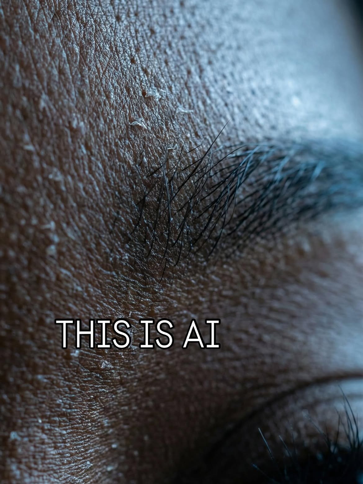 Macro photograph of a brow and forehead showing skin texture, flaking and individual hairs